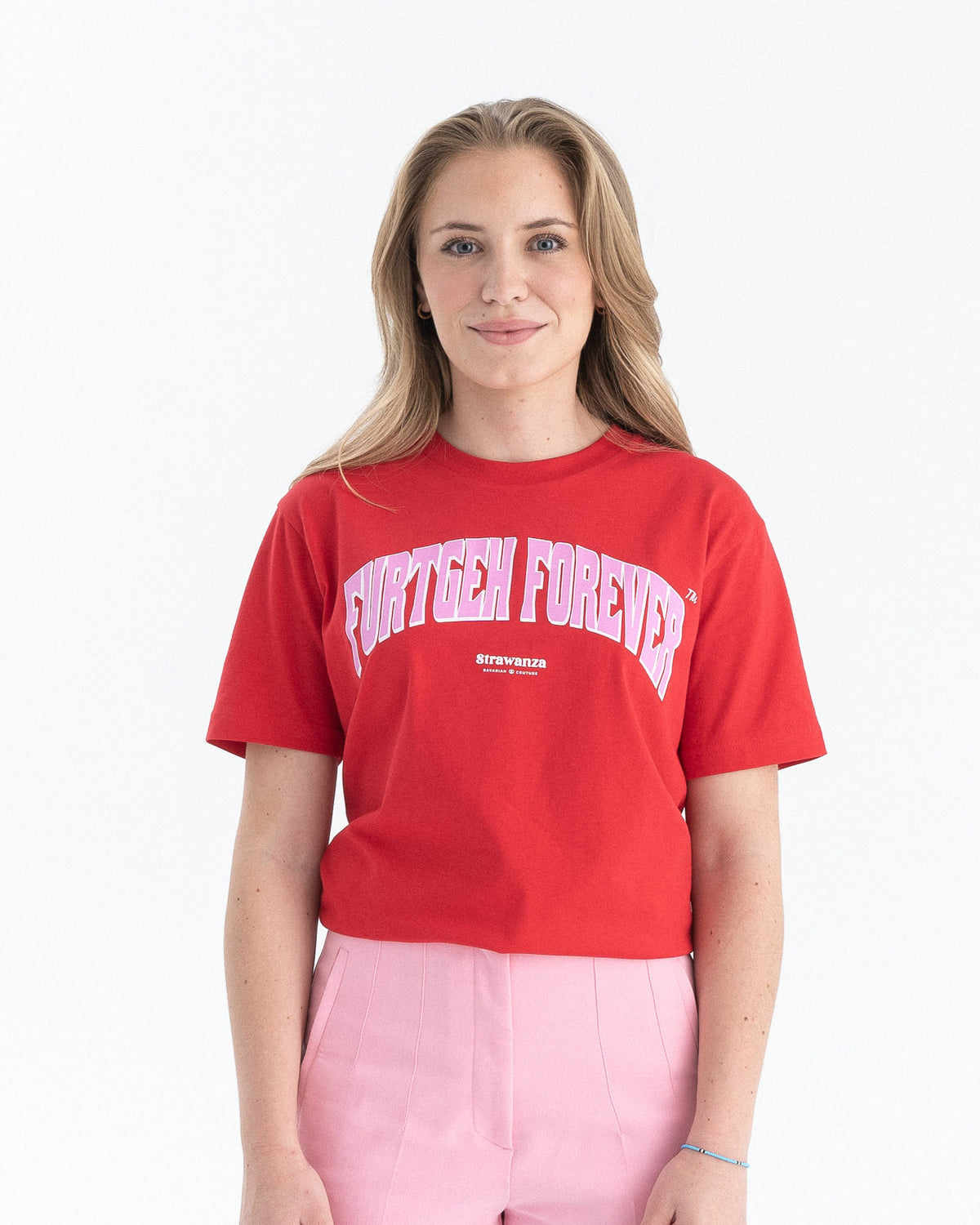 Weibliches Model trägt ein rotes T-Shirt mit einem großen, rosanen "FURTGEH FOREVER" Schriftzug vorne auf der Brust.
